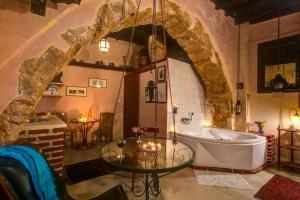 a bathroom with a tub and a glass table at Ifigenia by Captain Michalis in Chania