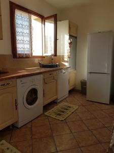 a kitchen with a washing machine and a refrigerator at Villa seynoise in La Seyne-sur-Mer