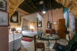 a bathroom with a tub and a bedroom with a bed at Ifigenia by Captain Michalis in Chania