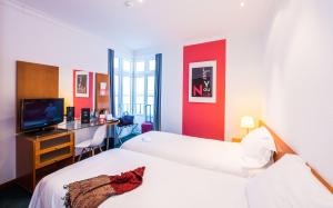 - une chambre avec 2 lits et un bureau avec une télévision dans l'établissement Stay Hotel Évora Centro, à Évora