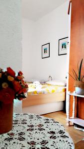 a bedroom with a bed and a vase of flowers at Apartment Mimmy in Dubrovnik