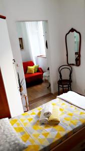 a bedroom with a bed with a yellow and white checkered blanket at Apartment Mimmy in Dubrovnik