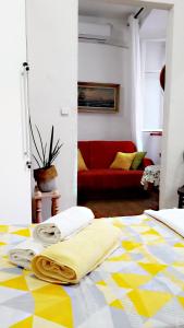a bedroom with a bed with a yellow and white floor at Apartment Mimmy in Dubrovnik