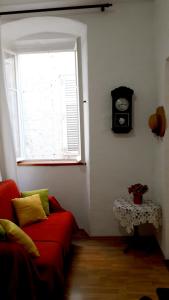 a living room with a red couch and a window at Apartment Mimmy in Dubrovnik