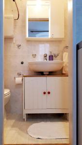 a bathroom with a sink and a mirror and a toilet at Apartment Mimmy in Dubrovnik