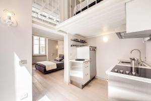 a white apartment with a bed in a room at Vaccarella Pantheon in Rome
