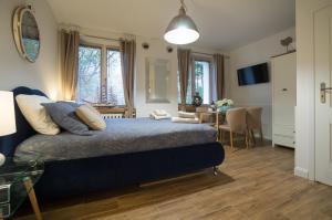a bedroom with a bed and a dining room at Blue Boat Apartment Sopot in Sopot