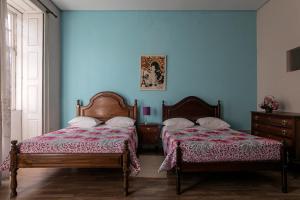 A bed or beds in a room at Veneza
