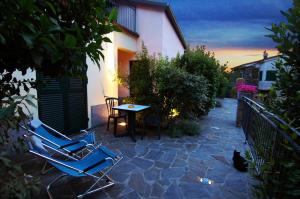 a patio with two chairs and a table and a cat at Cinqueterre Residence in Riomaggiore