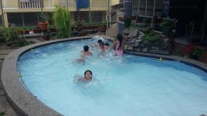 a group of people in a swimming pool at Fuentes del Volcán in Baños