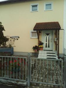 dom z białymi drzwiami i płotem w obiekcie Ferienwohnung Roth w mieście Memmingen