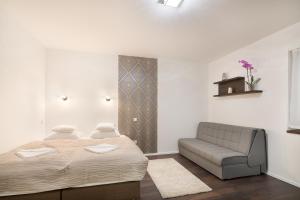 Ένα ή περισσότερα κρεβάτια σε δωμάτιο στο Paulay Downtown Apartments