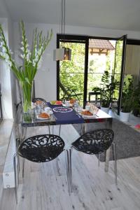 a glass table with chairs and food on it at Dream - Victoria Residence by OneApartments in Sopot