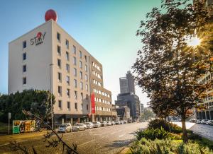 a street with cars parked on the side of a building at Stay Hotel Porto Centro Trindade in Porto