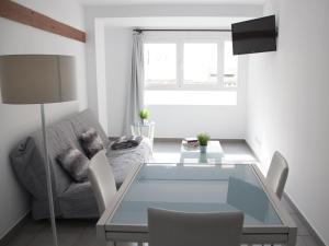 a living room with a glass table and a couch at Flats Friends Tetuan in Valencia
