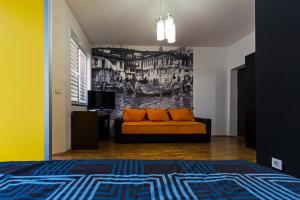 a living room with a couch and a painting on the wall at DJ Apartments Plus in Ohrid