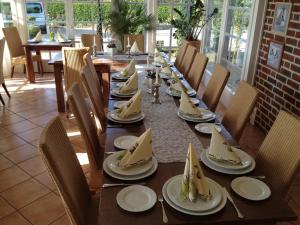 a long wooden table with plates of food on it at Hotel Restaurant Zum Heidekrug in Bersenbrück +22 photos
