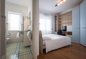 Ένα ή περισσότερα κρεβάτια σε δωμάτιο στο L'ippocampo Guest House