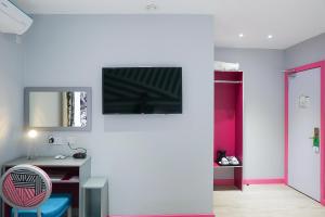 A television and/or entertainment center at Best Western London Peckham Hotel