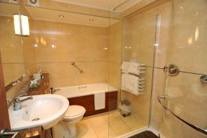 a bathroom with a sink and a toilet and a shower at Expanse Hotel in Bridlington