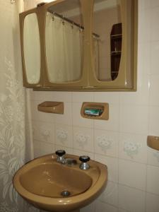 a bathroom with a sink and a mirror at Edificio Riazor n° IX in San Clemente del Tuyú +15 photos