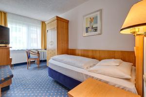 Postel nebo postele na pokoji v ubytování Hotel am Feuersee