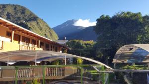 a view of a building with a mountain in the background at Fuentes del Volcán in Baños