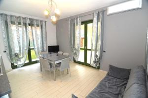 uma sala de estar com uma mesa e um sofá em Residence Samarcanda em Budoni