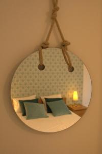 a mirror on a wall with a bed with pillows at Alcaiceria in Granada