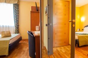 Postel nebo postele na pokoji v ubytování SIRIOHotel