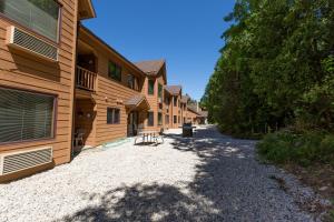 a gravel road next to a row of buildings at The Landing Resort in Egg Harbor