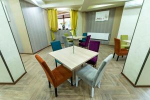 a dining room table and chairs in a room at Prestige Boutique Hotel Craiova in Craiova