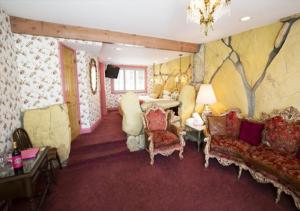 a living room with a couch chairs and a table at Madonna Inn in San Luis Obispo