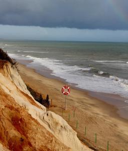 a view of a beach with a red sign at CASA 19 in Albufeira