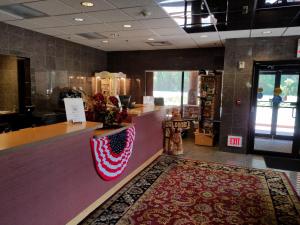 a store lobby with a red and white rug on the floor at Rushmore Express & Suites in Keystone