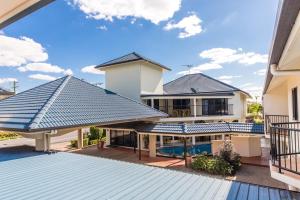 
a large white and blue house with a balcony at Villa Capri Motel in Rockhampton
