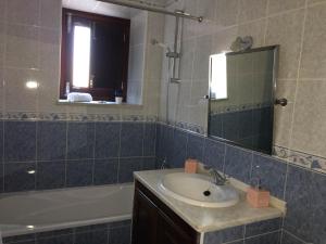 a bathroom with a sink and a tub and a mirror at Refúgio da Vila in Monsaraz +36 photos