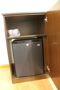 a small black refrigerator in a kitchen with a counter at Hotel El Castillo in Ponferrada