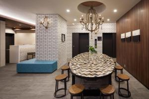 a dining room with a table and stools at the b shimbashi toranomon in Tokyo