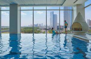 a group of people standing in a swimming pool at Shangri-La Songbei, Harbin in Harbin