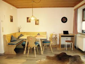 a dining room with a table and chairs at Haus Geierberg in Filzmoos