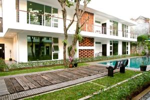 a villa with a swimming pool and a house at Ampera Avenue Residence in Jakarta