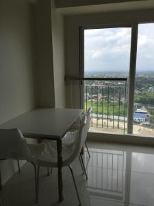 a table and two chairs in a room with a window at 05-06 at Wind Residences Tagaytay in Tagaytay