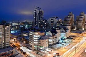 a city skyline with tall buildings at night at Центр! Папанинцев 111-53 in Barnaul