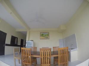 a kitchen with a dining room table and chairs at Pluto House in Canggu
