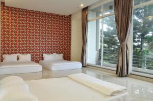 Giường trong phòng chung tại Mekong Hotel & Restaurant