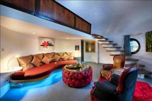 a living room with a large bed and a staircase at Bel Air Resort in Gili Islands