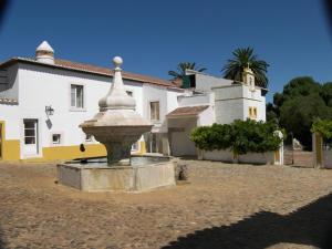 a large stone fountain in front of a building at Monte da Amoreira in Elvas
