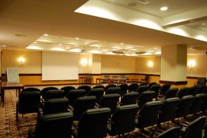 a conference room with chairs and a podium in it at Grand Hotel Victory in Aktau +104 photos