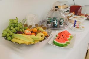 a table with a bunch of fruits and vegetables on it at Bellini Home B&B in Catania